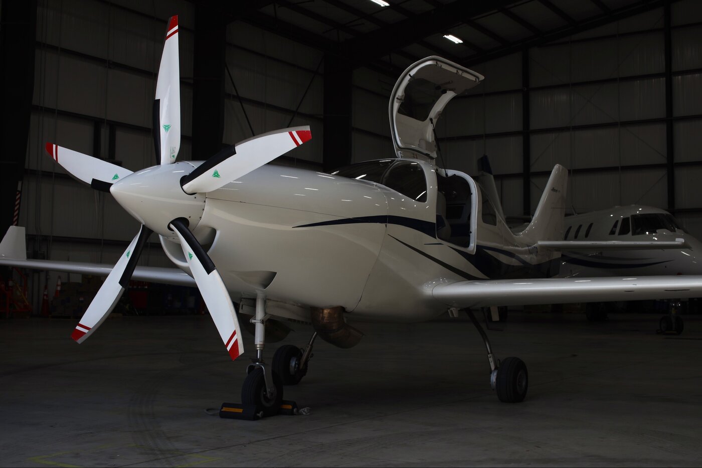 Lancair IV-P JetProp N331TP front three-quarter view in hangar showing Garrett TPE-331-6 turboprop engine cowl